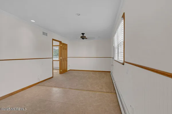 a view of a big room with wooden floor and cabinet