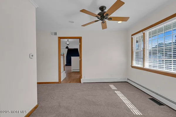 a view of a livingroom with a ceiling fan and window