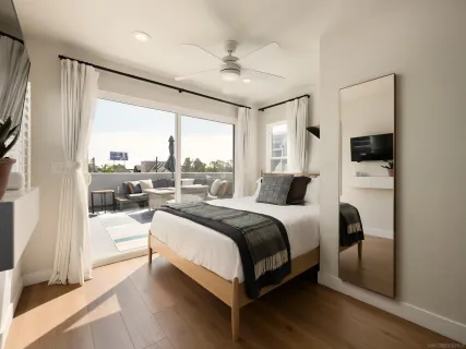 a bedroom with a bed and a large window