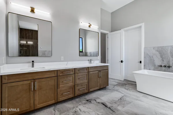a bathroom with a granite countertop shower