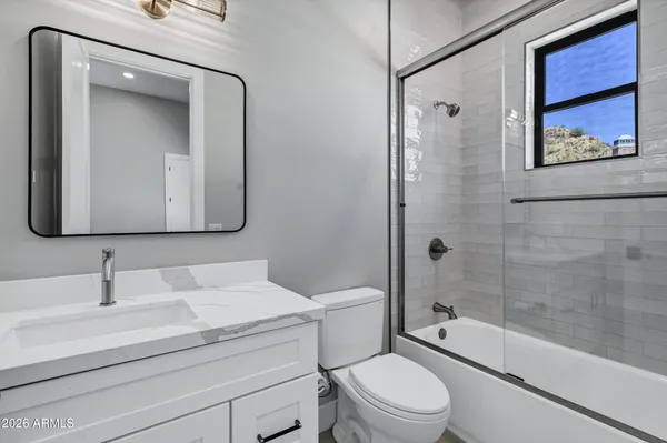 a kitchen with stainless steel appliances granite countertop a sink a stove and a white cabinets