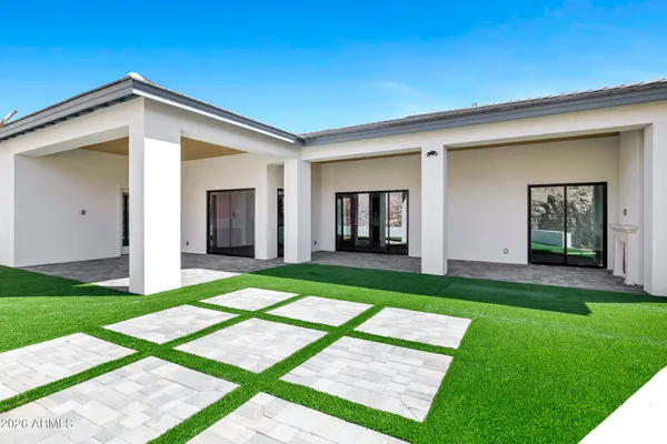 a backyard of a house with table and chairs