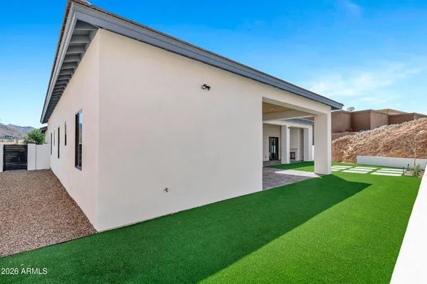 a view of a house with backyard and porch