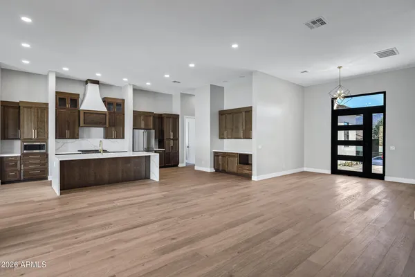 a kitchen with kitchen island a counter top space cabinets and stainless steel appliances