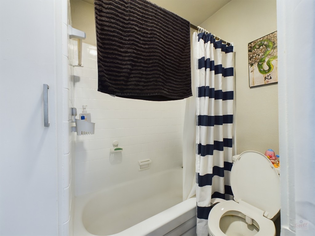 304 East 33rd Street, Unit 8 Austin, TX 78705 - Photo 11 of 14 a bathroom with a shower toilet and sink