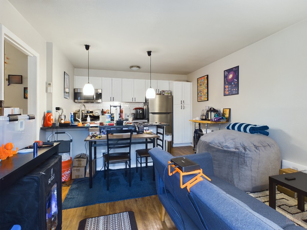 304 East 33rd Street, Unit 8 Austin, TX 78705 - Photo 5 of 14 a living room with lots of furniture and kitchen view