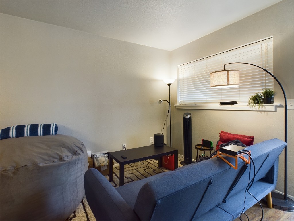 304 East 33rd Street, Unit 8 Austin, TX 78705 - Photo 6 of 14 a living room with furniture and a window