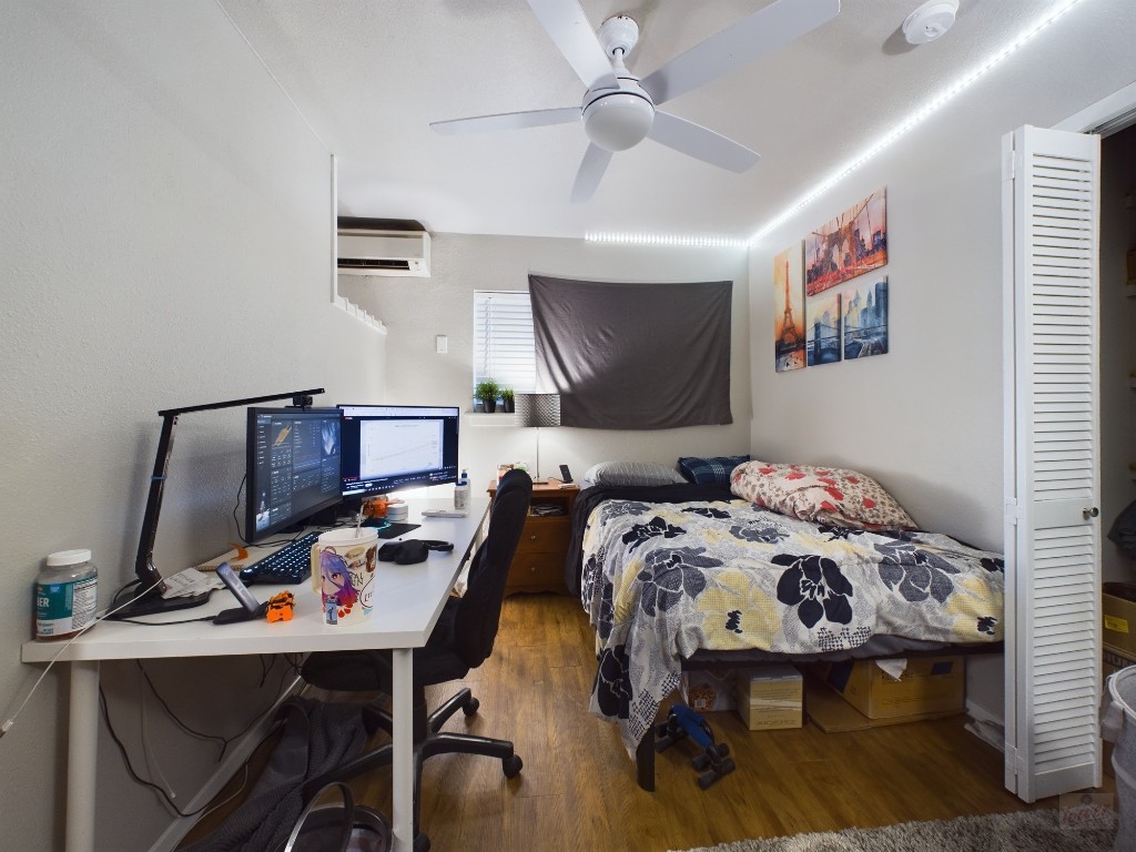 304 East 33rd Street, Unit 8 Austin, TX 78705 - Photo 9 of 14 a bedroom with a bed and a desk