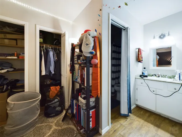 a view of walk in closet with clothes and shoes