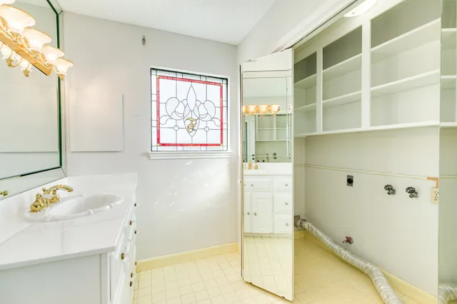 a bathroom with a bathtub sink and mirror