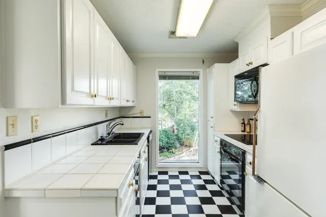 a kitchen with a stove a sink and a refrigerator