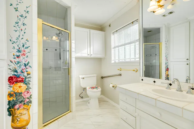 a bathroom with a sink toilet and shower