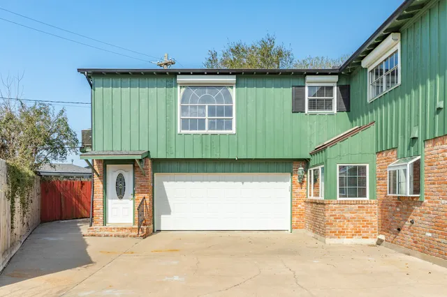 a front view of a house with a garage