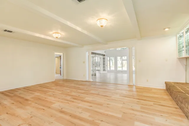 a view of an empty room with glass door