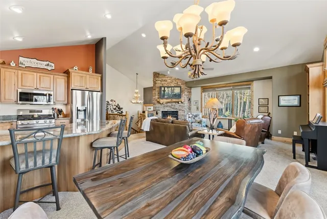 a view of a dining room with furniture a chandelier and wooden floor