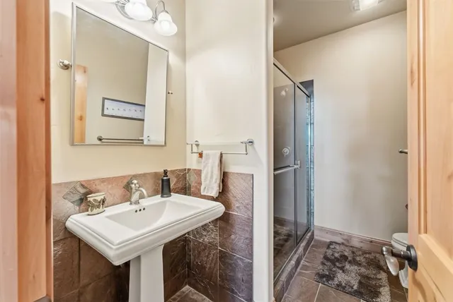 a bathroom with a sink a mirror and a shower