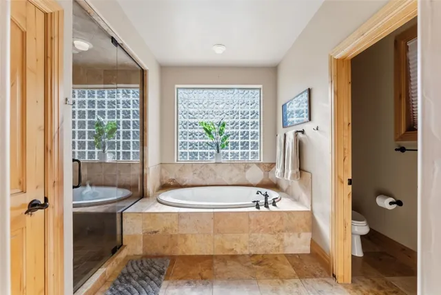 a bath tub sitting in a bathroom next to a window