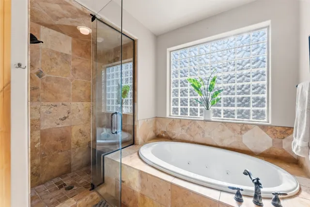 a bath tub sitting in a bathroom next to a window