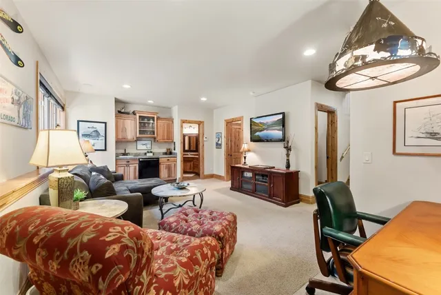 a living room with fireplace furniture and a flat screen tv