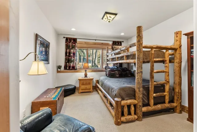 a bedroom with furniture and a large window