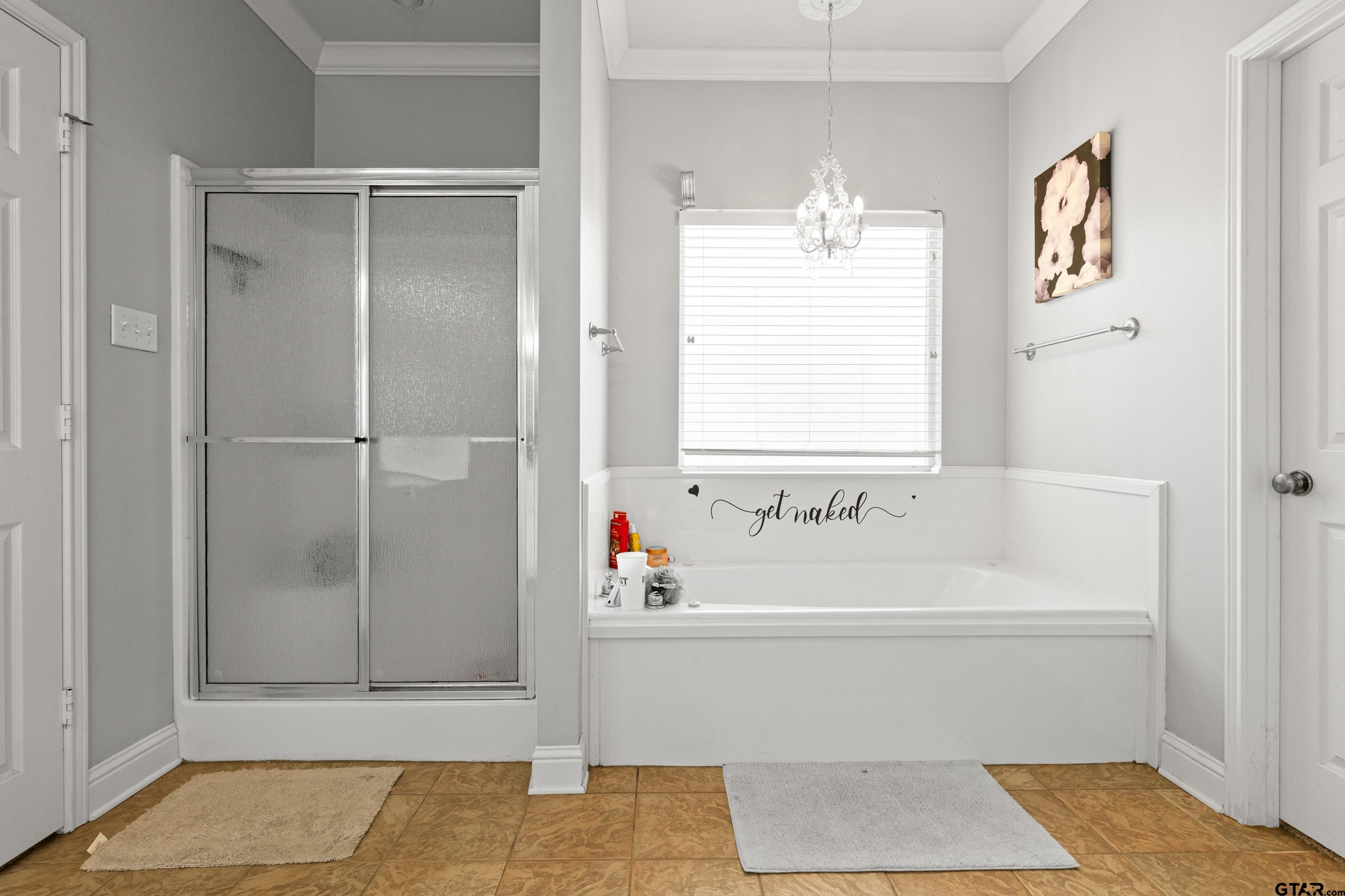 5201 Whitaker Circle Longview, TX 75605 - Photo 16 of 40 a bathroom with a bathtub and a shower