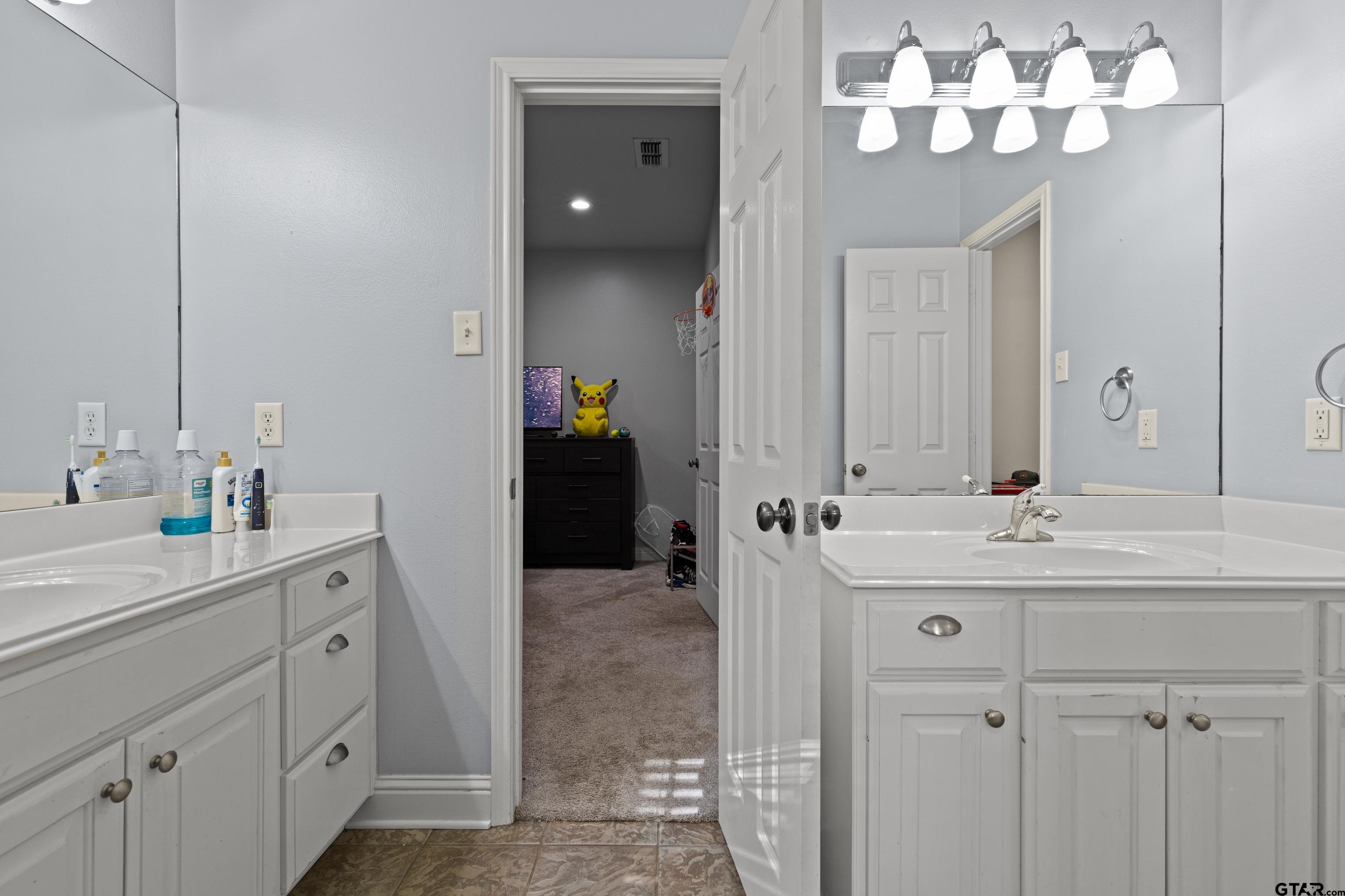 5201 Whitaker Circle Longview, TX 75605 - Photo 25 of 40 a bathroom with a sink vanity and a mirror