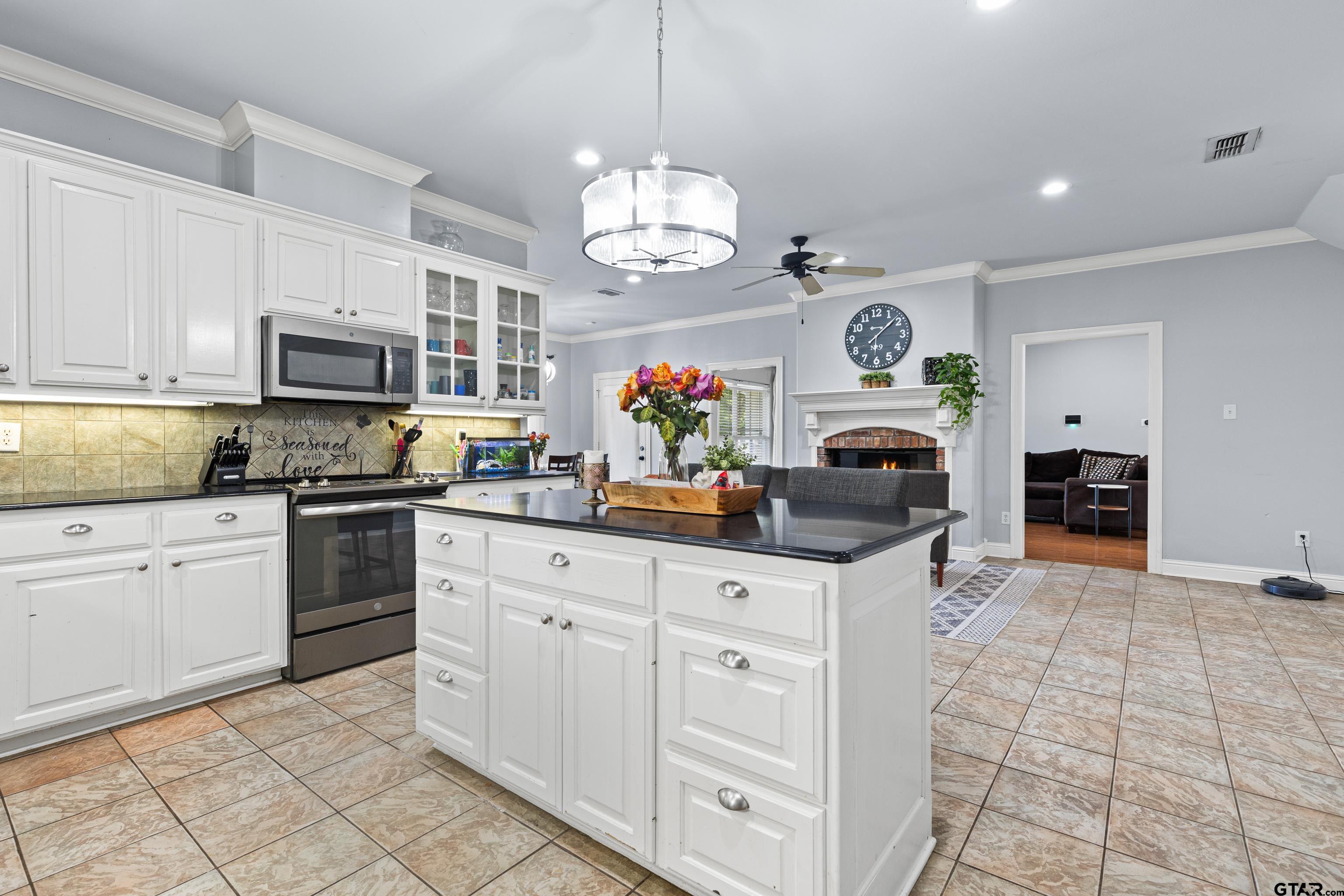 5201 Whitaker Circle Longview, TX 75605 - Photo 10 of 40 a kitchen with granite countertop a sink stove and cabinets
