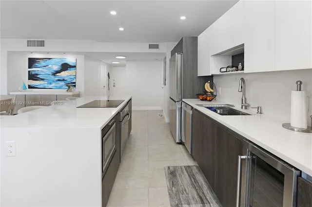 a kitchen with stainless steel appliances a sink stove and cabinets