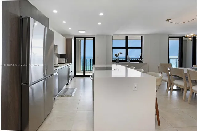 a kitchen with stainless steel appliances granite countertop a refrigerator and a sink