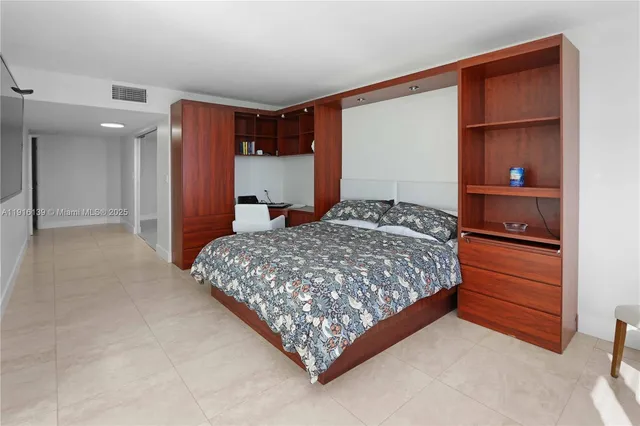 a bedroom with a large bed and a dresser