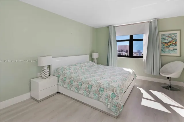 a bedroom with a bed and flat screen tv