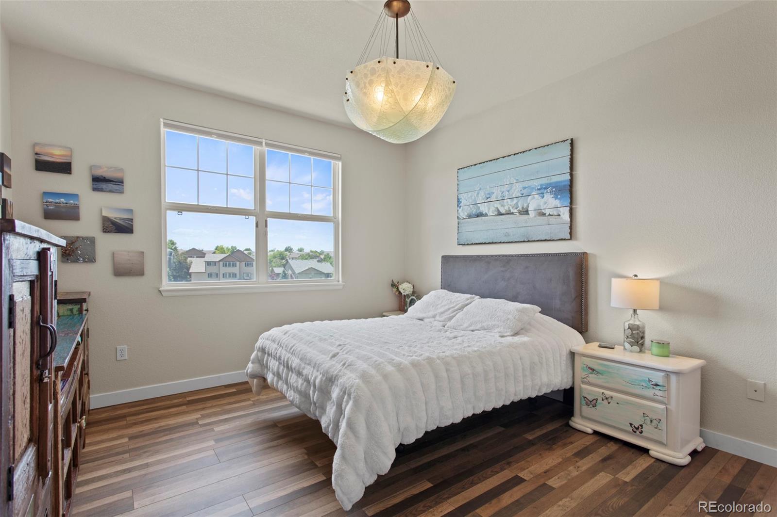 3703 South Perth Circle, Unit 101 Aurora, CO 80013 - Photo 13 of 30 a bedroom with a bed and a window