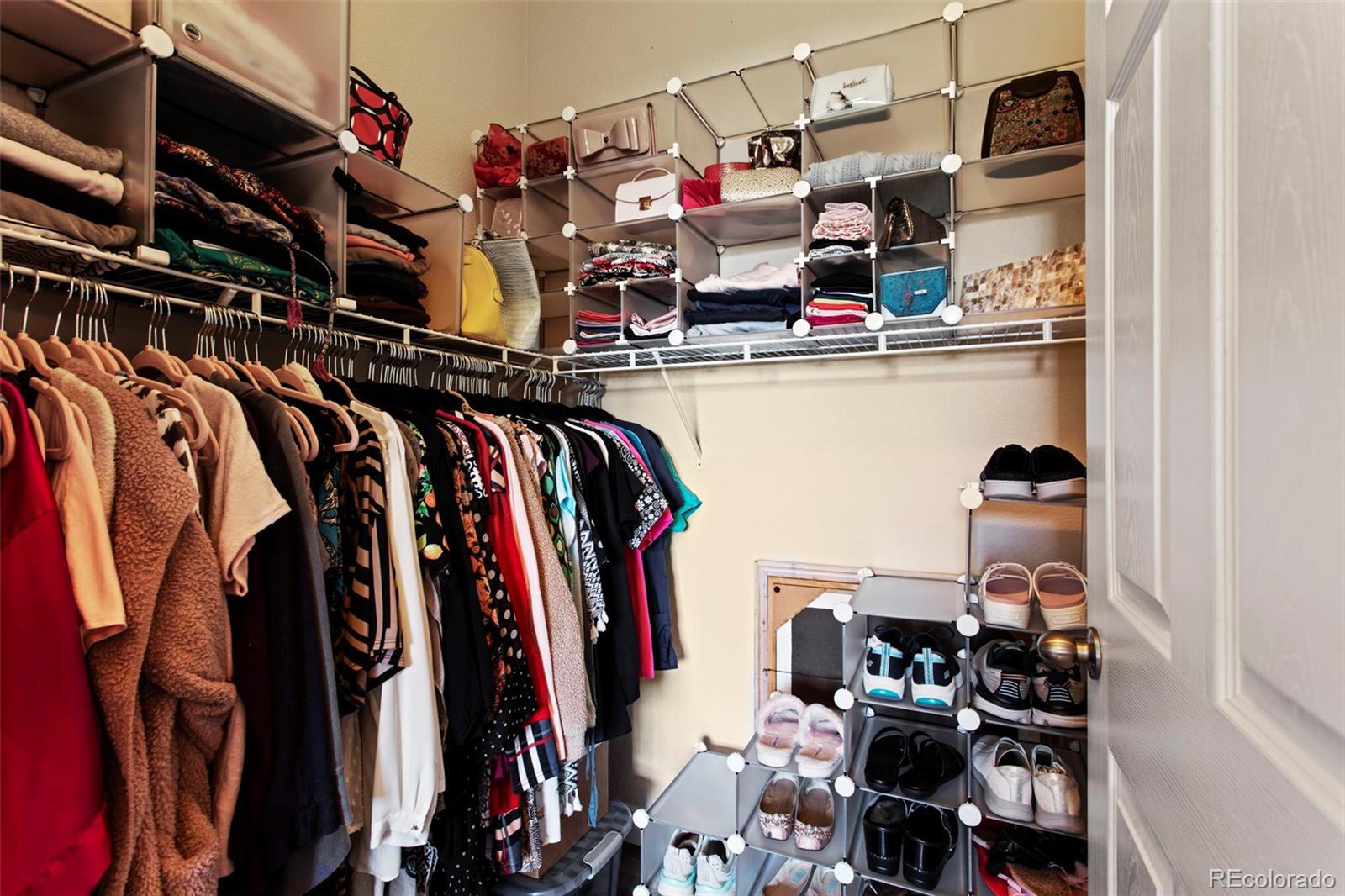 3703 South Perth Circle, Unit 101 Aurora, CO 80013 - Photo 17 of 30 a view of walk in closet with clothes and shoes