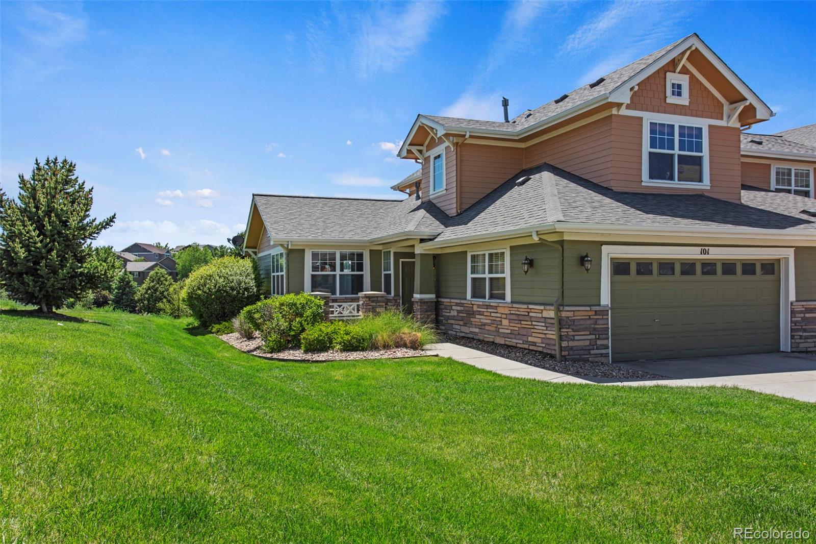 3703 South Perth Circle, Unit 101 Aurora, CO 80013 - Photo 2 of 30 a front view of a house with a yard