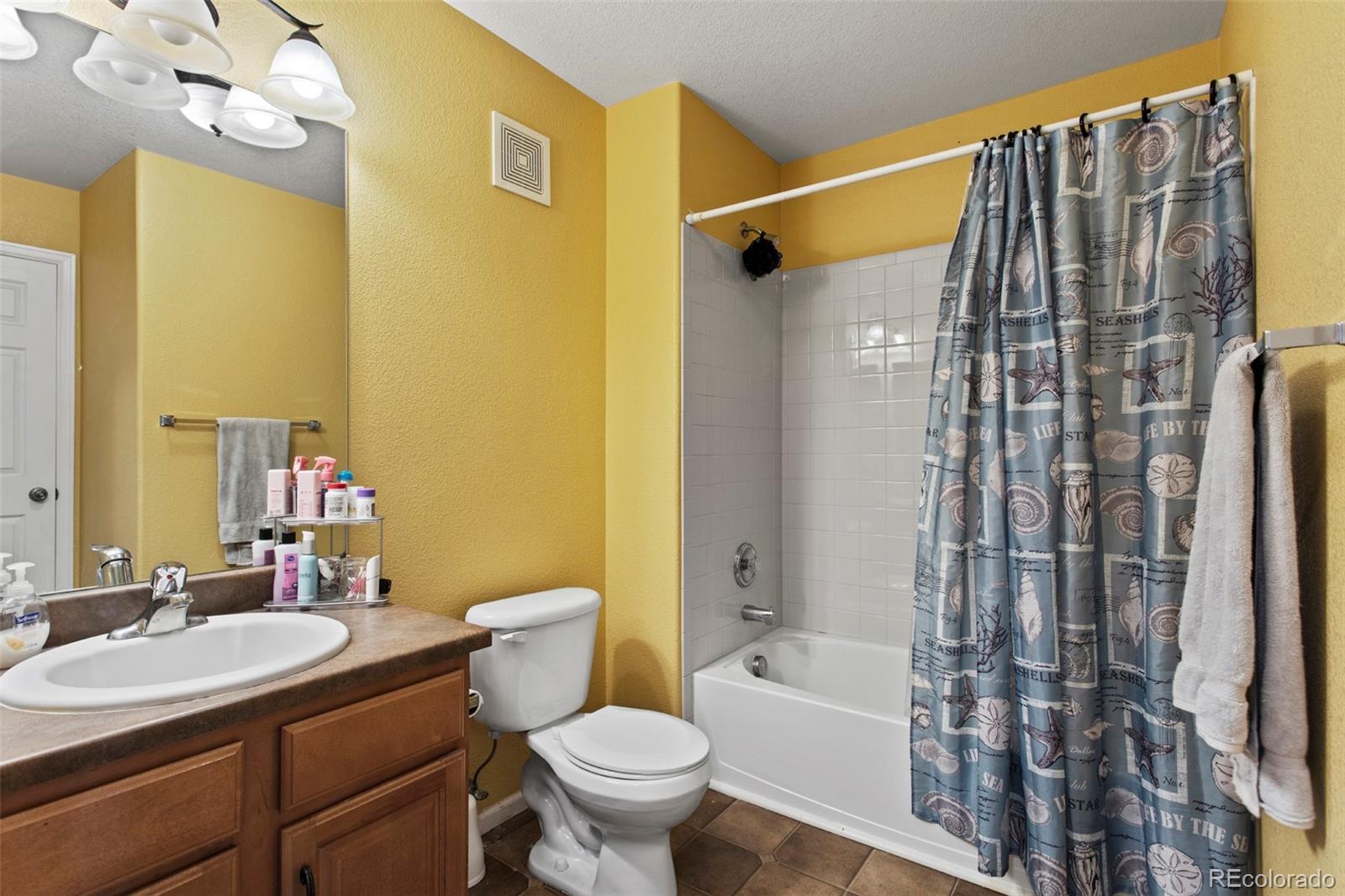 3703 South Perth Circle, Unit 101 Aurora, CO 80013 - Photo 25 of 30 a bathroom with a sink toilet and shower
