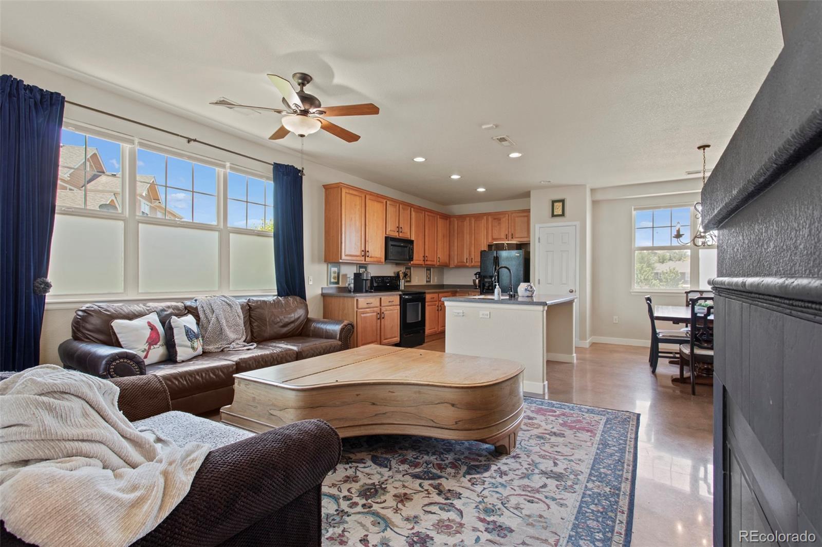 3703 South Perth Circle, Unit 101 Aurora, CO 80013 - Photo 4 of 30 a living room with furniture and a large window