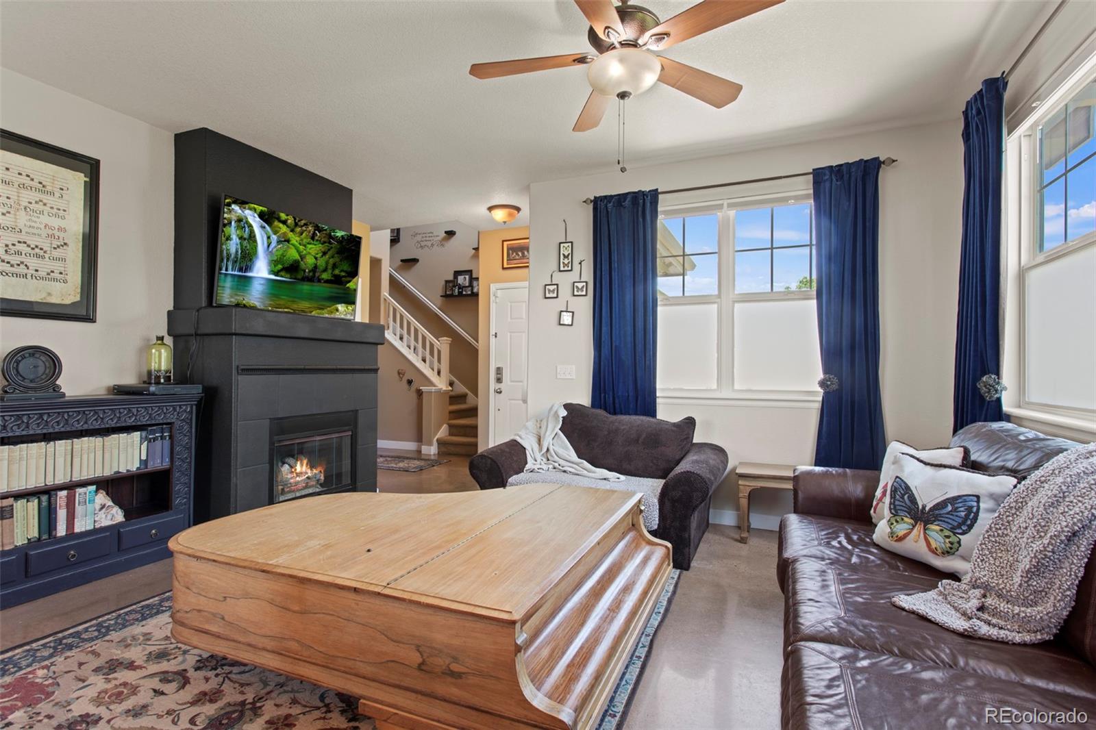 3703 South Perth Circle, Unit 101 Aurora, CO 80013 - Photo 5 of 30 a spacious bedroom with a bed and a flat screen tv