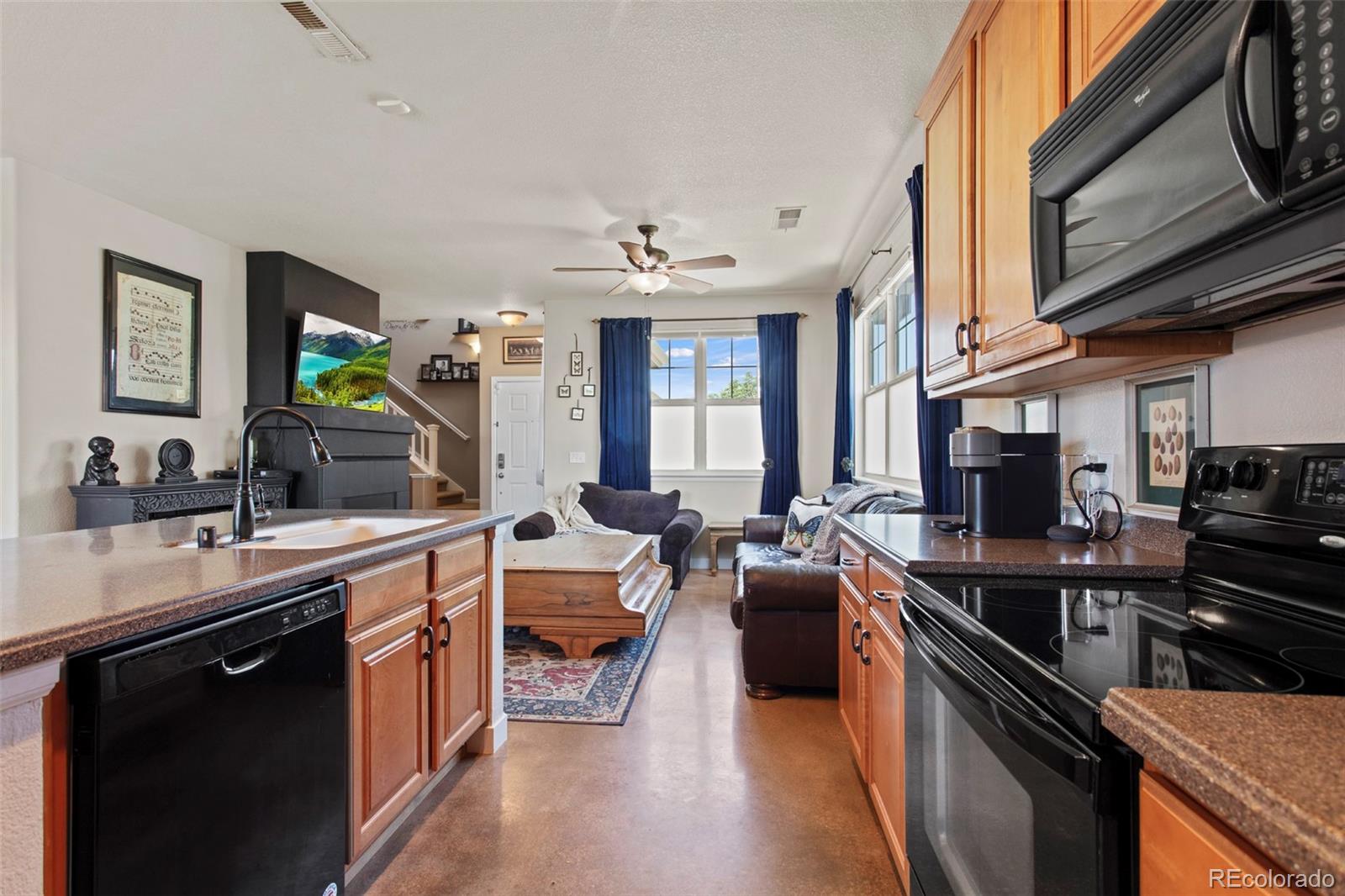 3703 South Perth Circle, Unit 101 Aurora, CO 80013 - Photo 9 of 30 a kitchen with lots of counter top space a sink appliances and cabinets