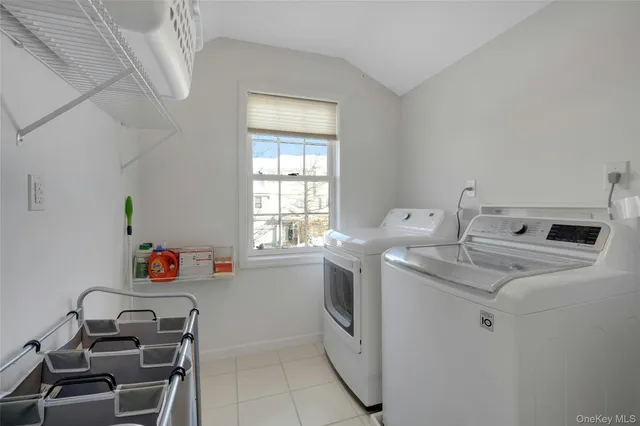 a utility room with cabinets washer and dryer