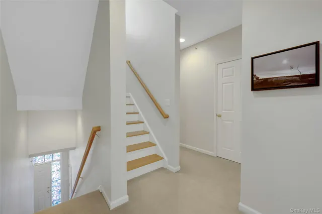 a view of entryway with wooden floor and stairs