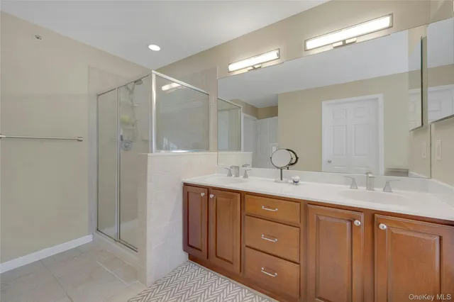 a bathroom with a double vanity sink and mirror