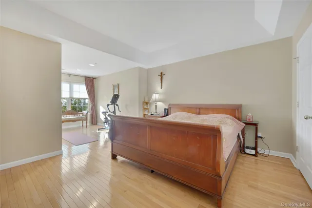 a bedroom with a bed a mirror and lamp