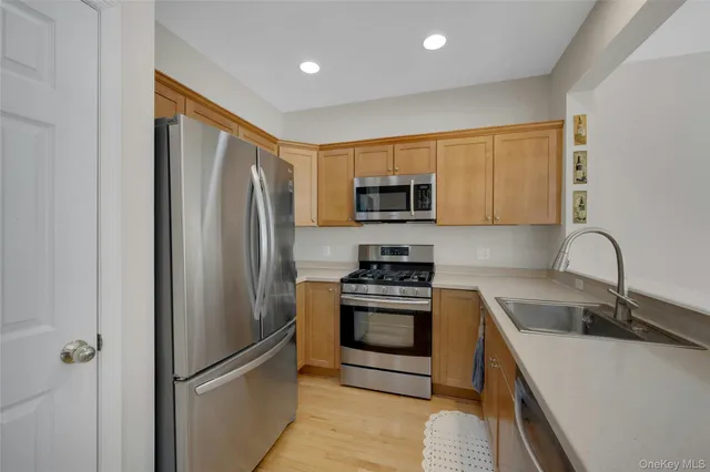a kitchen with stainless steel appliances granite countertop a refrigerator stove and sink