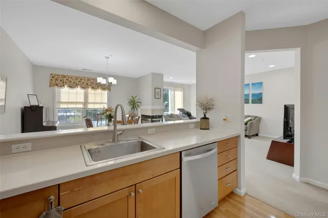a kitchen with stainless steel appliances a sink and a large window