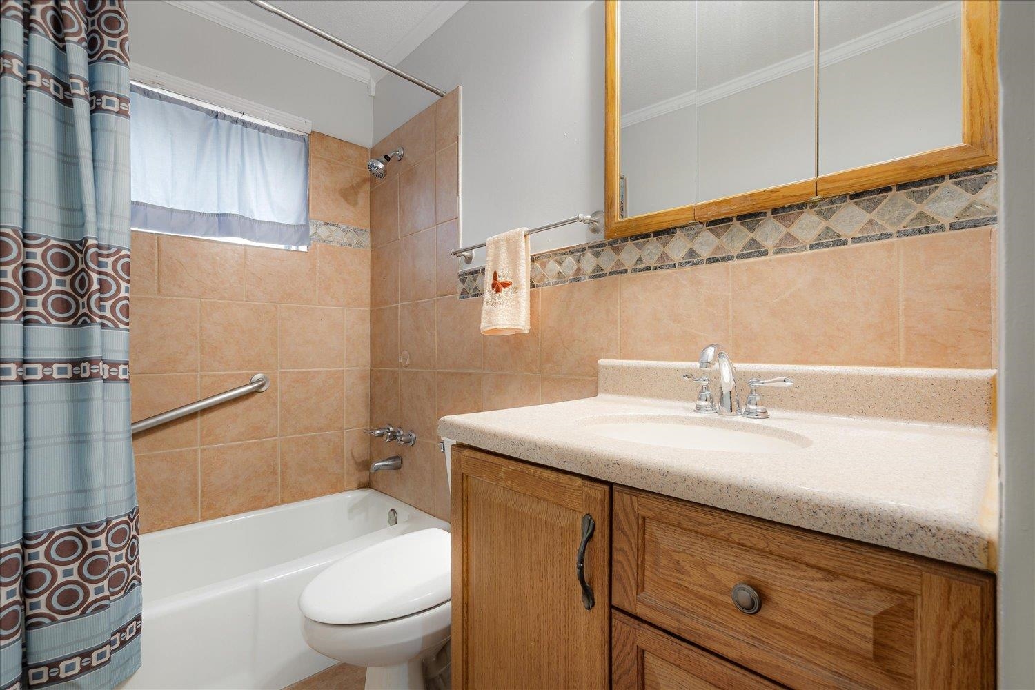 4141 Archer Drive Memphis, TN 38109 - Photo 22 of 26 a bathroom with a sink a toilet and shower