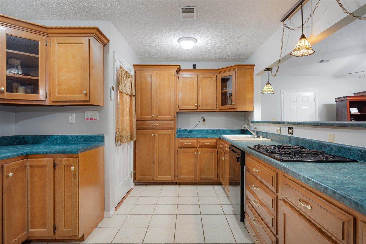 4141 Archer Drive Memphis, TN 38109 - Photo 7 of 26 a kitchen with stainless steel appliances granite countertop a stove a sink and a refrigerator