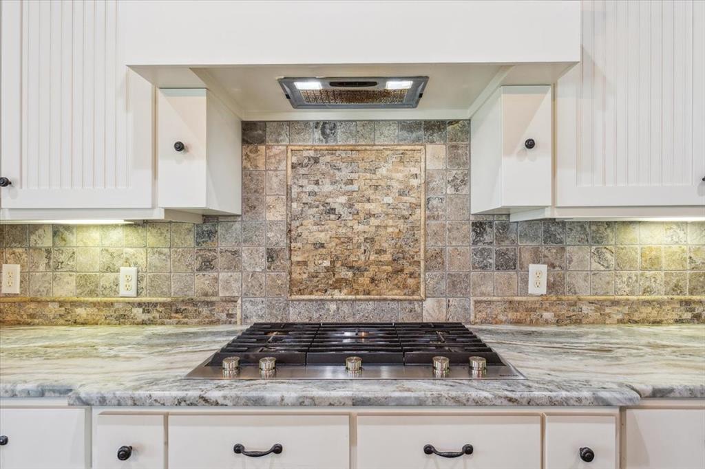 259 County Road 149 Riesel, TX 76682 - Photo 11 of 40 Kitchen featuring stainless steel gas cooktop, white cabinetry, tasteful backsplash, and light stone counters