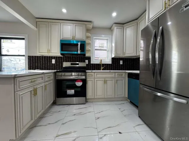 a kitchen with stainless steel appliances granite countertop a refrigerator sink and cabinets