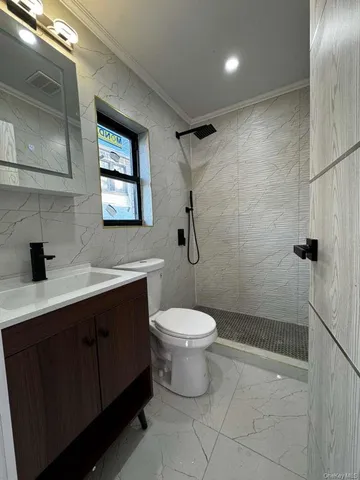 a bathroom with a toilet sink and shower
