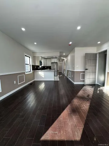 a view of kitchen with refrigerator and window